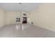 Open-concept living room with vaulted ceilings, neutral paint, tile floors, and decorative windows at 5290 White Sand Ne Cir, St Petersburg, FL 33703