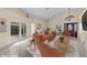Staged living room showcasing vaulted ceilings, neutral tile, and a decorative front door with natural light at 5290 White Sand Ne Cir, St Petersburg, FL 33703
