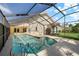 Inviting screened-in pool area with a view of the private backyard, perfect for relaxation and outdoor entertaining at 5290 White Sand Ne Cir, St Petersburg, FL 33703
