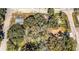 A high angle aerial view of a home surrounded by dense, mature trees and neighboring properties at 5401 E 14Th Ave, Tampa, FL 33619