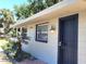 A bright single-story home with secure doors, window bars, and manicured landscaping at 5401 E 14Th Ave, Tampa, FL 33619