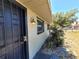 Close-up of the front entrance of a cozy single-story home showing secure doors and wall lighting at 5401 E 14Th Ave, Tampa, FL 33619