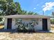 Charming single-story home featuring two front doors, secure window bars, and a neatly landscaped yard at 5401 E 14Th Ave, Tampa, FL 33619