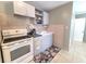 Cozy kitchen with white appliances and open shelving at 5401 E 14Th Ave, Tampa, FL 33619