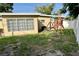 A spacious yard sits behind the house and a playset is in the background at 5443 Tangerine Dr, New Port Richey, FL 34652