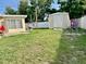 A small outdoor shed sits in the grassy backyard at 5443 Tangerine Dr, New Port Richey, FL 34652