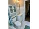 Bathroom featuring a vanity, mirrored medicine cabinet, toilet and shower with a decorative curtain at 5443 Tangerine Dr, New Port Richey, FL 34652