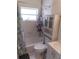 Compact bathroom featuring a shower-tub combination, a vanity, and tiled walls for easy maintenance at 5443 Tangerine Dr, New Port Richey, FL 34652