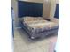 Comfortable bedroom with tiled flooring and a patterned bedspread, offering a relaxing retreat at 5443 Tangerine Dr, New Port Richey, FL 34652