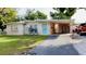 Charming single story house with a covered carport and a well-maintained front yard at 5443 Tangerine Dr, New Port Richey, FL 34652