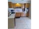 Functional kitchen design with ample cabinet space, tile flooring, and essential appliances at 5443 Tangerine Dr, New Port Richey, FL 34652
