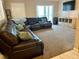 Living room with sectional leather couch, a TV and a cabinet at 5443 Tangerine Dr, New Port Richey, FL 34652