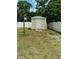 A backyard storage shed is featured in a fenced yard at 5443 Tangerine Dr, New Port Richey, FL 34652
