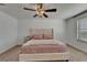 Bedroom featuring a plush bed, ceiling fan and a window at 5942 Sweet Birch Dr, Riverview, FL 33578