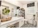 Bright bathroom with a large mirror, modern vanity, and decorative black and white floor tiles at 626 Marphil Loop, Brandon, FL 33511