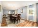 Formal dining room with wood floors, stylish lighting fixture, a decorative rug and bright windows at 626 Marphil Loop, Brandon, FL 33511