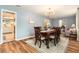 Dining room showcases wooden floors, decorative rug, and views of the living room and kitchen at 626 Marphil Loop, Brandon, FL 33511