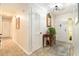 Inviting foyer with tiled floor, mirror, console table and decorative rug at 626 Marphil Loop, Brandon, FL 33511