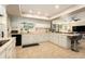 Open kitchen with white cabinetry, granite countertops and convenient breakfast bar seating at 626 Marphil Loop, Brandon, FL 33511