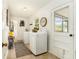 Bright laundry room with full-sized washer and dryer and access to outdoors at 626 Marphil Loop, Brandon, FL 33511