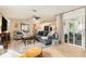Open living room with comfortable seating, ceiling fan, and sliding glass door to a screened porch at 626 Marphil Loop, Brandon, FL 33511