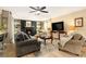Comfortable living room with a brick fireplace, custom built-ins, and ceiling fan at 626 Marphil Loop, Brandon, FL 33511