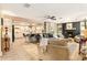 Open-concept living room flows into a modern kitchen, featuring a fireplace and ample seating at 626 Marphil Loop, Brandon, FL 33511