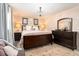 Serene main bedroom with a dark wood furniture, plush bedding, and a chandelier at 626 Marphil Loop, Brandon, FL 33511