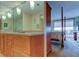 Bathroom vanity with cabinets open to bedroom with four poster bed at 6265 Sun Blvd # 805, St Petersburg, FL 33715