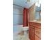 Cozy bathroom featuring a tub, shower, and vanity with a granite countertop and cherry wood cabinets at 6265 Sun Blvd # 805, St Petersburg, FL 33715