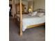 Cozy bedroom with a four-poster bed, decorative bedding, plush carpet, and warm lighting at 6265 Sun Blvd # 805, St Petersburg, FL 33715