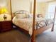 Cozy bedroom featuring a four poster bed, soft neutral tones, and carpet flooring at 6265 Sun Blvd # 805, St Petersburg, FL 33715