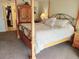 Comfortable bedroom showcasing a four poster bed, carpet floors and closet area at 6265 Sun Blvd # 805, St Petersburg, FL 33715
