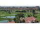 Resort community with golf course, ponds, and multiple residential buildings with red tile roofs at 6265 Sun Blvd # 805, St Petersburg, FL 33715