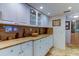 Bright kitchen features marble countertops and sleek white cabinetry with glass door inserts at 6265 Sun Blvd # 805, St Petersburg, FL 33715