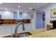Bright kitchen features marble countertops and sleek white cabinetry with stainless steel faucet at 6265 Sun Blvd # 805, St Petersburg, FL 33715