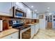 Bright kitchen features marble countertops, sleek white cabinetry and stainless steel appliances at 6265 Sun Blvd # 805, St Petersburg, FL 33715