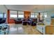 Spacious living room features large windows offering panoramic views, plush seating and a mirrored wall at 6265 Sun Blvd # 805, St Petersburg, FL 33715