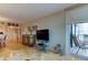 Spacious living room features large windows, balcony access, and view into dining room at 6265 Sun Blvd # 805, St Petersburg, FL 33715