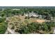 Aerial view showing neighborhood with lots of trees, park and tennis court at 6709 N 13Th St, Tampa, FL 33604