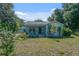 Charming single-story home with a welcoming front porch and well-manicured lawn at 6709 N 13Th St, Tampa, FL 33604