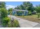 Inviting single-story home featuring a quaint front porch and well-maintained landscaping at 6709 N 13Th St, Tampa, FL 33604