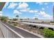 Balcony with views of covered parking, the sky, and manicured landscaping creates a serene condo environment at 7 Island Park Pl # 204, Dunedin, FL 34698