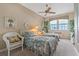 Charming bedroom featuring two twin beds, a ceiling fan, and plenty of natural light at 7 Island Park Pl # 204, Dunedin, FL 34698