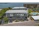 Enjoy water views and palm trees at this multi-story building, with parking, in this aerial shot at 7 Island Park Pl # 204, Dunedin, FL 34698