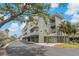A stylish condo complex featuring multiple stories, balconies, mature trees, and convenient covered parking at 7 Island Park Pl # 204, Dunedin, FL 34698