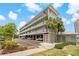 Exterior view of the condo building showcasing its well-maintained landscaping and covered parking at 7 Island Park Pl # 204, Dunedin, FL 34698