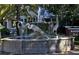 Artistic fountain featuring crane statues, set within a lush park landscape at 7 Island Park Pl # 204, Dunedin, FL 34698