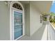 Entrance to a unit with storm door and nautical decor at 7 Island Park Pl # 204, Dunedin, FL 34698