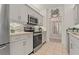 Modern kitchen featuring stainless steel appliances, sleek gray cabinetry, and elegant backsplash at 7 Island Park Pl # 204, Dunedin, FL 34698